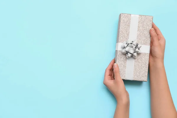 Female Hands Gift Box White Bow Blue Background — Stockfoto