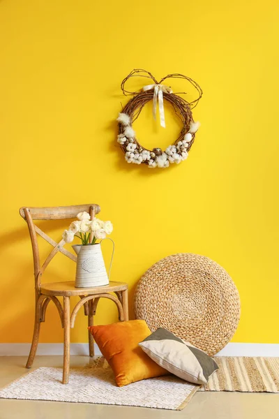 Chair Flowers Vase Pillows Pouf Easter Wreath Yellow Wall — Stock Photo, Image