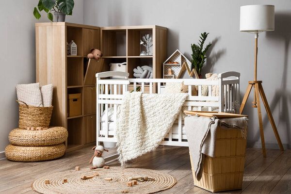 Interior of children's bedroom with baby crib and shelving unit