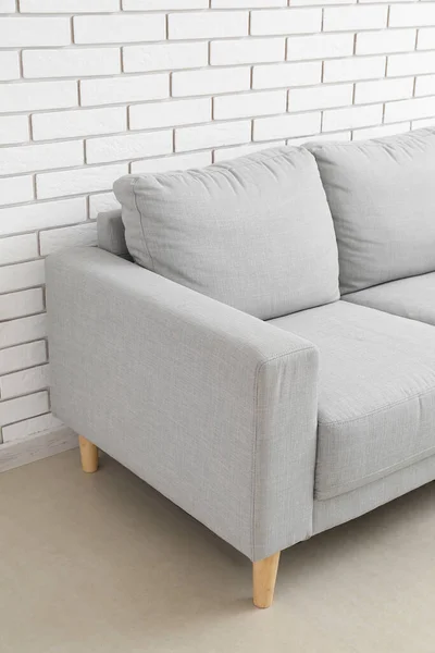 Stylish Grey Sofa White Brick Wall — стоковое фото