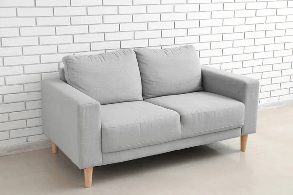 Stylish Grey Sofa White Brick Wall — Stock Fotó