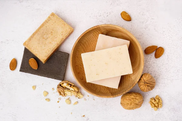 Composition with natural soap and nuts on light background