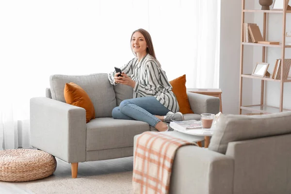 Young Woman Using Mobile Phone Grey Sofa Home — Stock Photo, Image