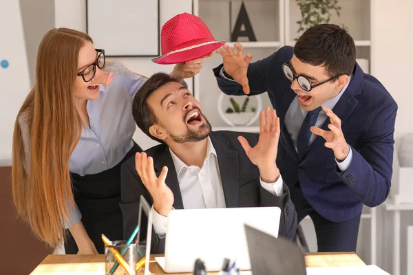 Colleagues Funny Disguise Putting Hat Boss Office April Fools Day — Stock Photo, Image