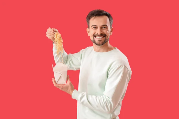 Handsome Man Box Chinese Noodles Red Background — Stockfoto