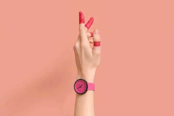 stock image Woman with painted fingers and stylish wristwatch on pink background