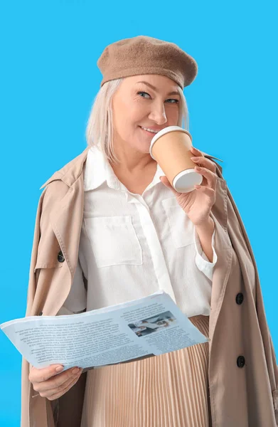 Stylish Mature Woman Coffee Newspaper Light Blue Background — Φωτογραφία Αρχείου