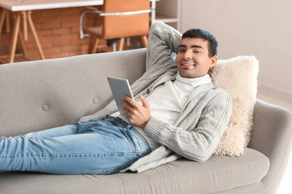 Young Man Using Tablet Computer Grey Sofa Home — Stock Photo, Image