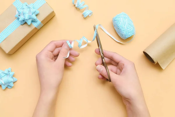 Woman Cutting Blue Plaid Ribbon Gift Box Beige Background — Stok fotoğraf