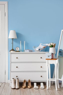 Interior of stylish hall with drawers and table clipart