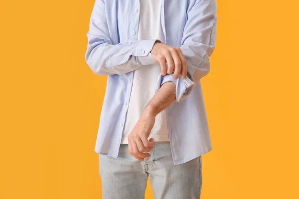 Young Man Rolling His Sleeve Yellow Background — Stock Photo, Image