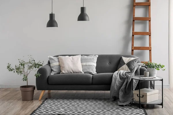 Interior of living room with cozy sofa and ladder