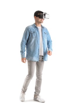 Young man using VR glasses on white background