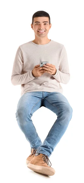 Красивий Хлопець Мобільним Телефоном Сидить Кріслі Білому Тлі — стокове фото
