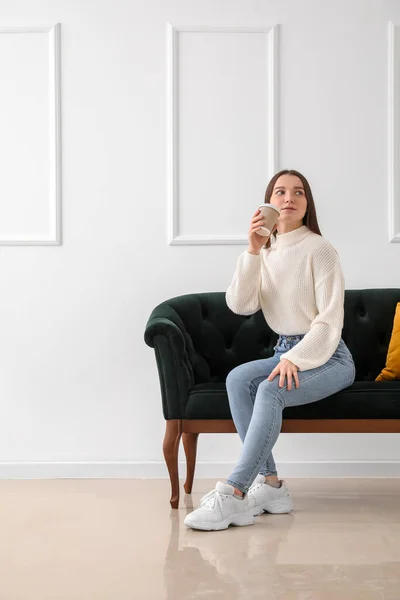 Young Woman Cup Coffee Sitting Green Sofa Light Wall — Stock Photo, Image