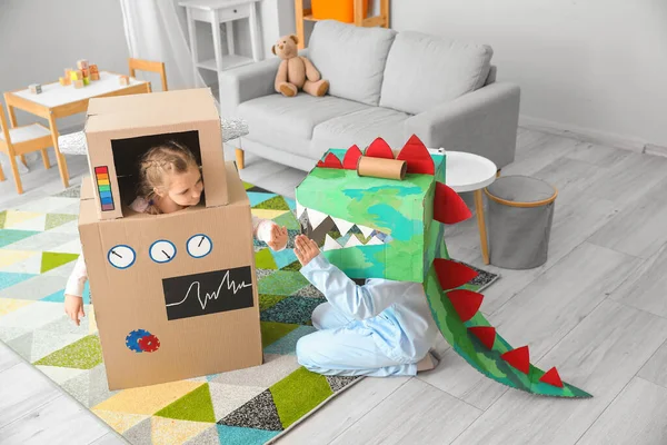 stock image Little children in cardboard costumes playing at home