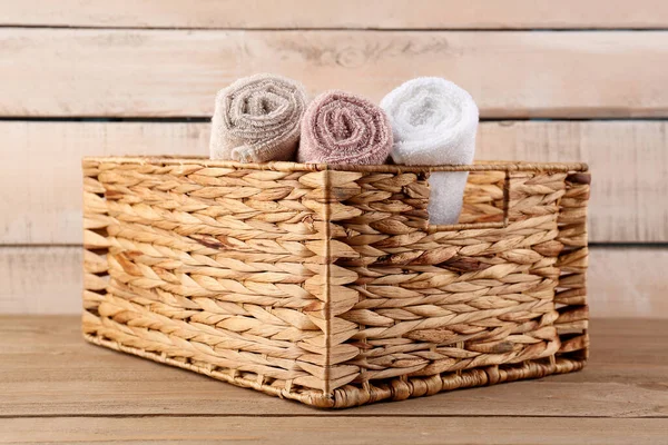 Wicker Basket Rolled Cotton Towels Wooden Table — Stock Photo, Image