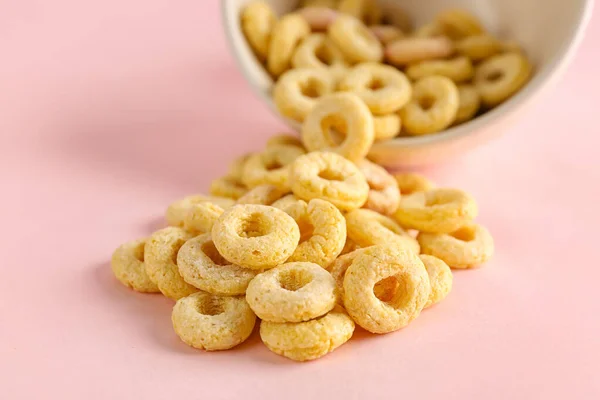 Overturned Bowl Yellow Cereal Rings Pink Background Closeup — Stock Photo, Image