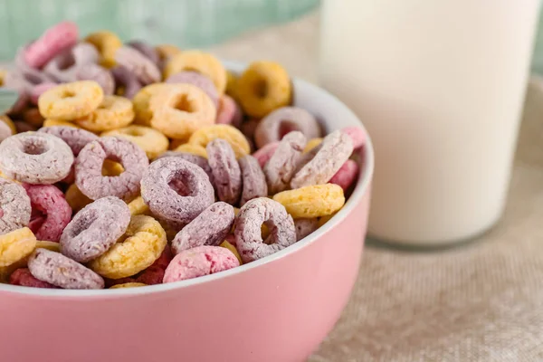 Bowl of colorful cereal rings on napkin, closeup