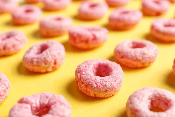 Many Pink Cereal Rings Yellow Background — Stock Photo, Image