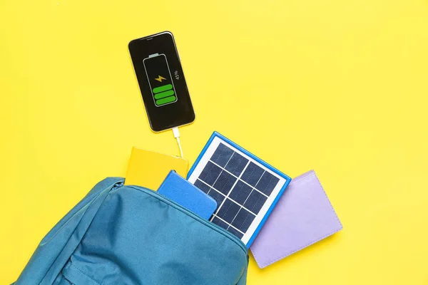 Bag Notebooks Portable Solar Panel Charging Mobile Phone Yellow Background — Stock Photo, Image