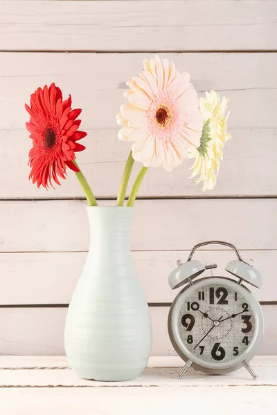 Alarm Clock Vase Beautiful Gerbera Flowers Wooden Background — Stock Photo, Image