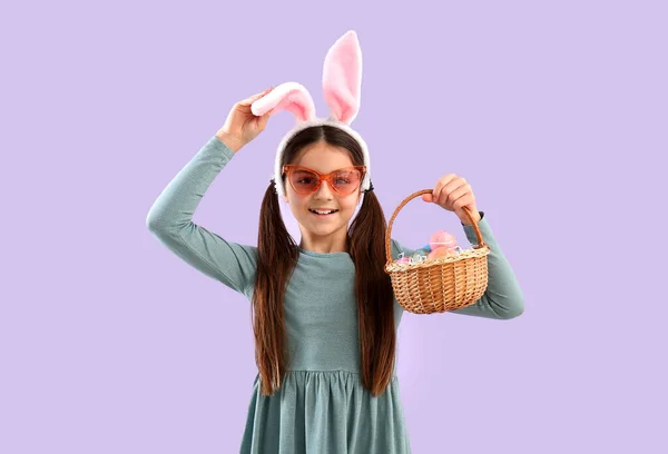 Little Girl Bunny Ears Basket Easter Eggs Lilac Background — Φωτογραφία Αρχείου