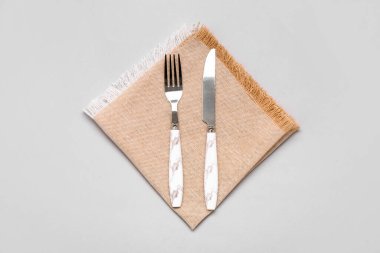 Napkin with cutlery on white background