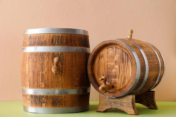 Wooden barrels on table near beige wall