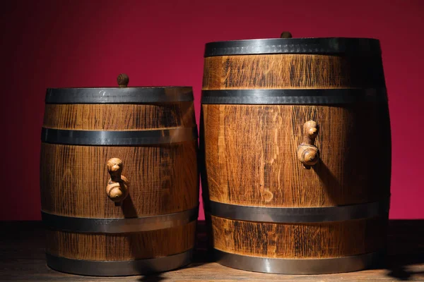 Wooden barrels on table near pink wall