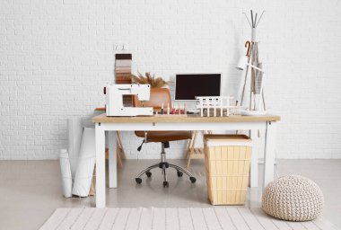 Interior of atelier with workplace and sewing supplies