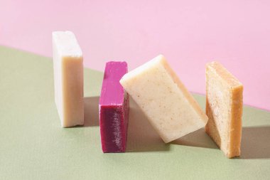 Set of natural soap bars on color background