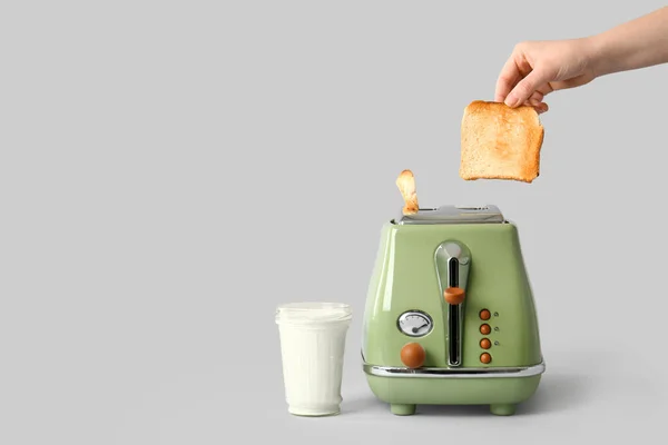 Woman Taking Crispy Bread Slice Modern Toaster Glass Milk Grey — Stock Photo, Image