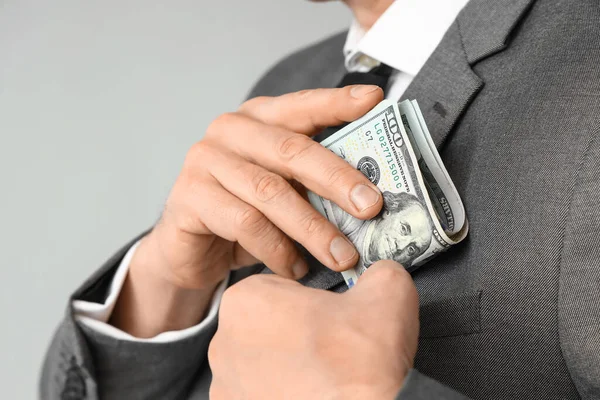 Businessman Putting Bribe Pocket Grey Background Closeup — Stock Photo, Image