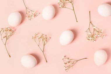 Paskalya yumurtaları ve pembe arka planda çingene çiçekleri ile kompozisyon
