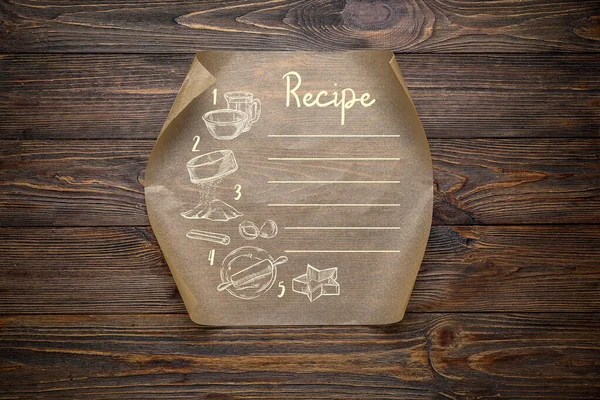 木製の背景にレシピのための場所とベーキングペーパーのシート — ストック写真