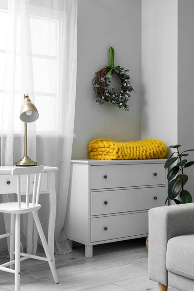 stock image Interior of living room with Easter wreath and drawers