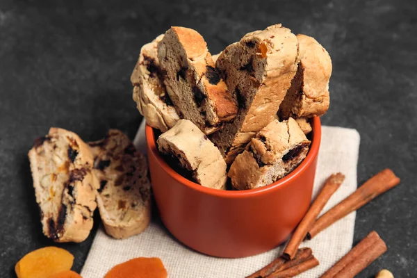 Bowl Delicious Biscotti Cookies Dried Apricots Cinnamon Black Grunge Background — Stock Photo, Image