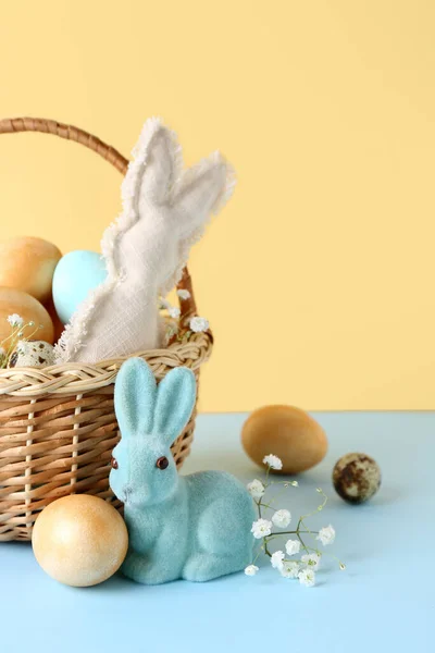 Basket Easter Eggs Bunnies Gypsophila Flowers Blue Table Beige Background — Stock Photo, Image