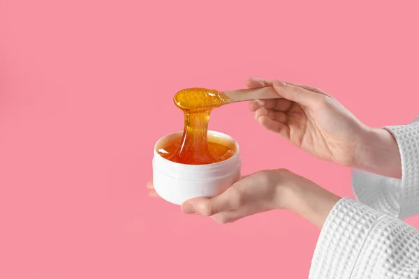 stock image Hands with sugaring paste on pink background