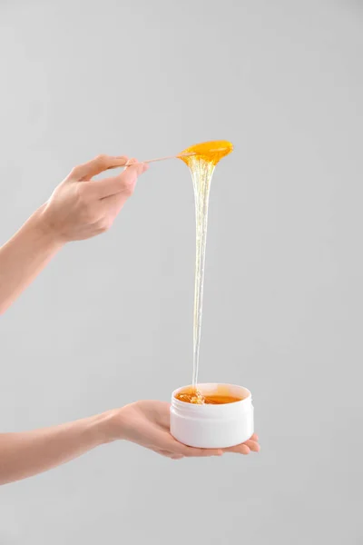 stock image Hands with sugaring paste on light background