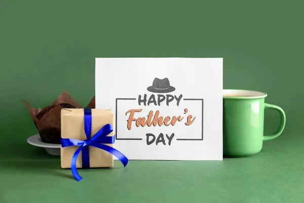 Greeting card for Father\'s Day, gift, muffin and cup of coffee on green background