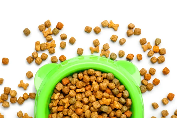 Bowl of dry pet food isolated on white background, closeup