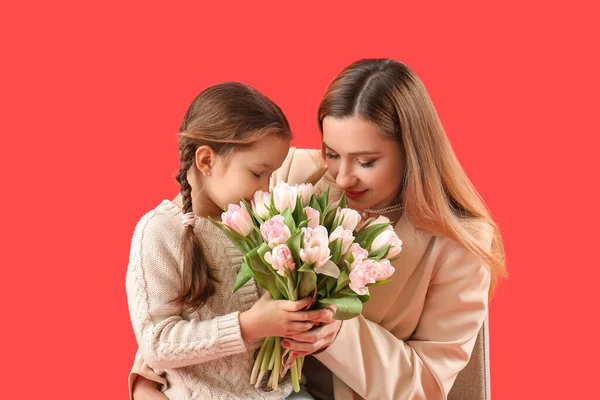 Cute Little Girl Greeting Her Mother Tulips Red Background — Stock Photo, Image