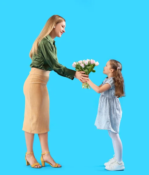 Cute Little Girl Greeting Her Mother Tulips Blue Background — Stock Photo, Image