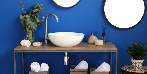 Wooden Stand Sink Supplies Blue Wall Bathroom — Stock Photo, Image