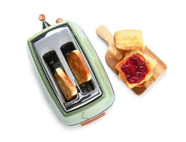 Bread slices in modern toaster and tasty toasts with jam isolated on white background