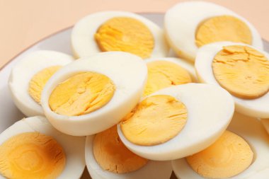 Bej arka planda kaynamış yumurta tabağı, yakın plan.