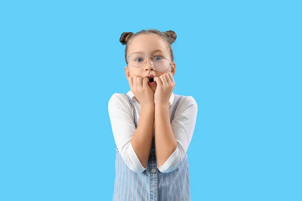 Stressed Little Girl Biting Nails Blue Background — Fotografie, imagine de stoc