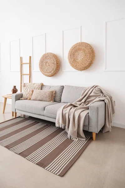 stock image Interior of light living room with grey couch, poufs and ladder